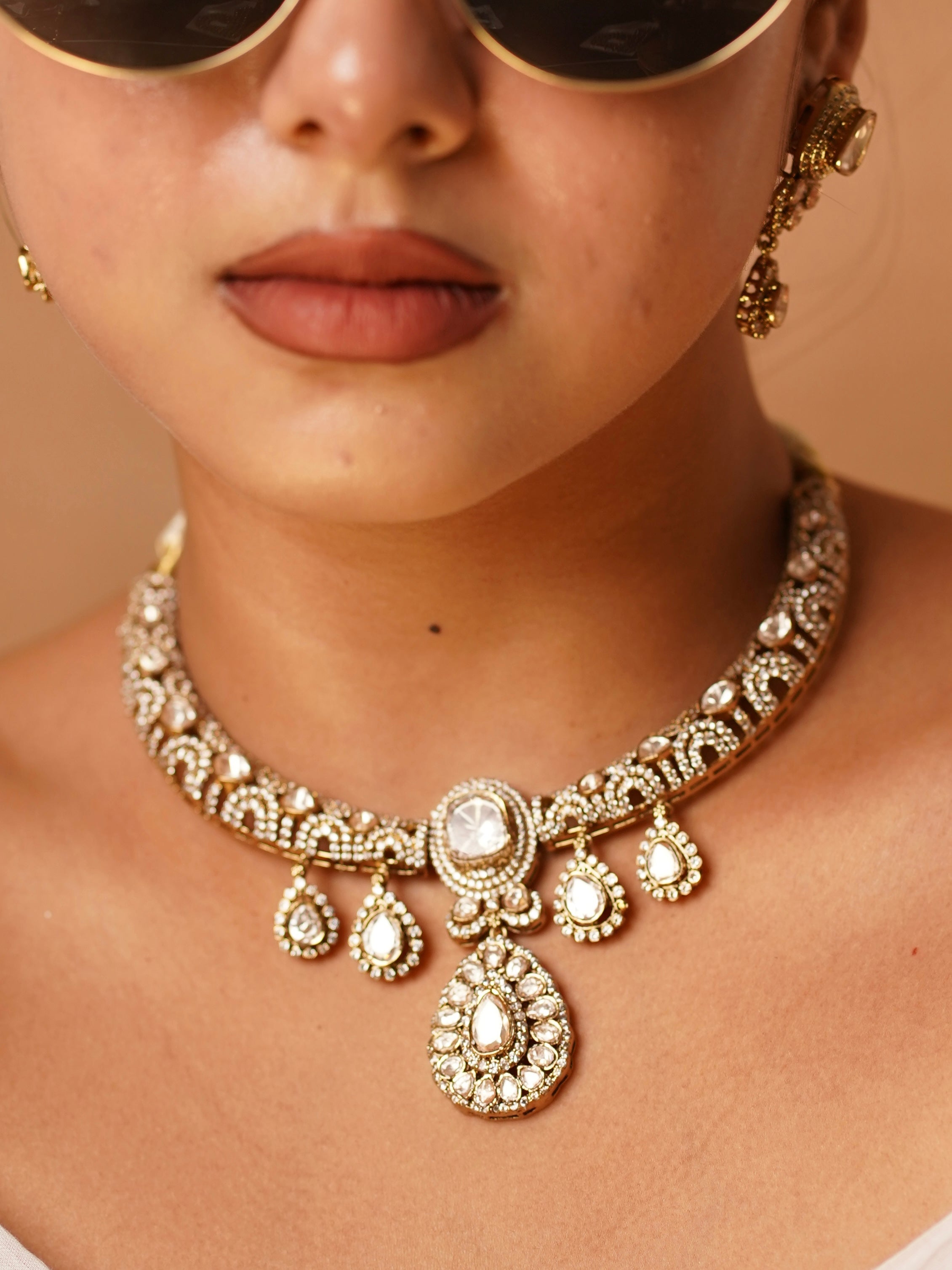 Side view of Aarvika necklace showing the curved hasli frame and sparkling polki elements